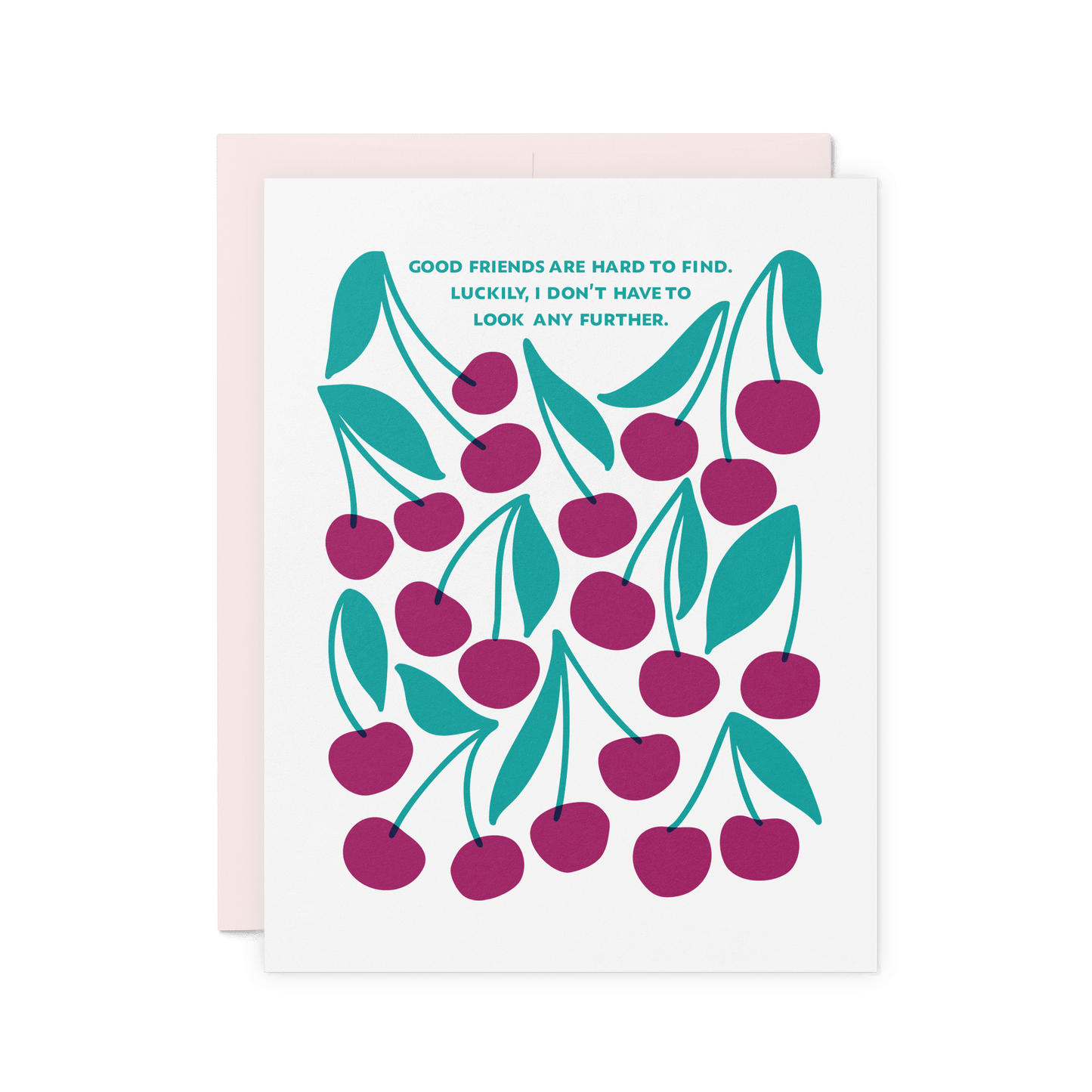 Friendship card with ‘Good friends are hard to find. Luckily, I don’t have to look any further.’ in teal hand lettering, featuring an illustrated pattern of merlot-colored cherries and green leaves on thick cotton paper.