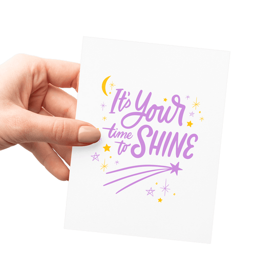 Hand holding an encouragement card with a shooting star illustration and hand-lettered typography, letterpress printed.