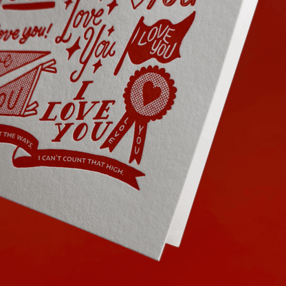 Card with 'I Love You' hand lettering and illustrations on a red background