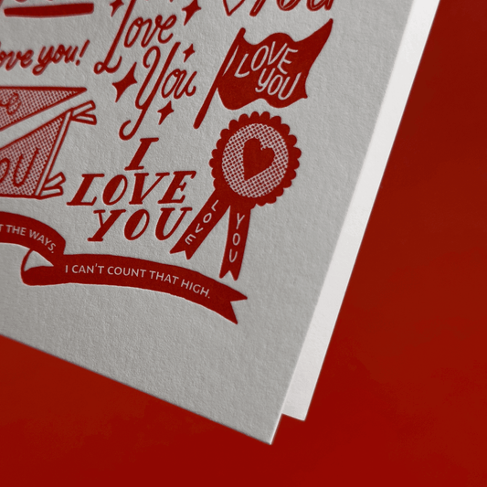 Card with 'I Love You' hand lettering and illustrations on a red background