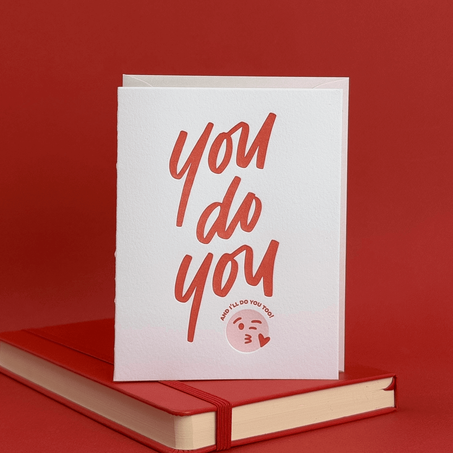 Greeting card with 'you do you' hand lettering on a red background