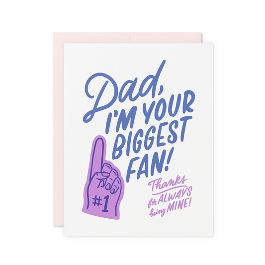 Heartfelt Father’s Day card with ‘Dad, I’m your biggest fan! Thanks for always being mine!’ in bold blue and lilac hand lettering, featuring a foam finger illustration, printed on thick cotton paper.