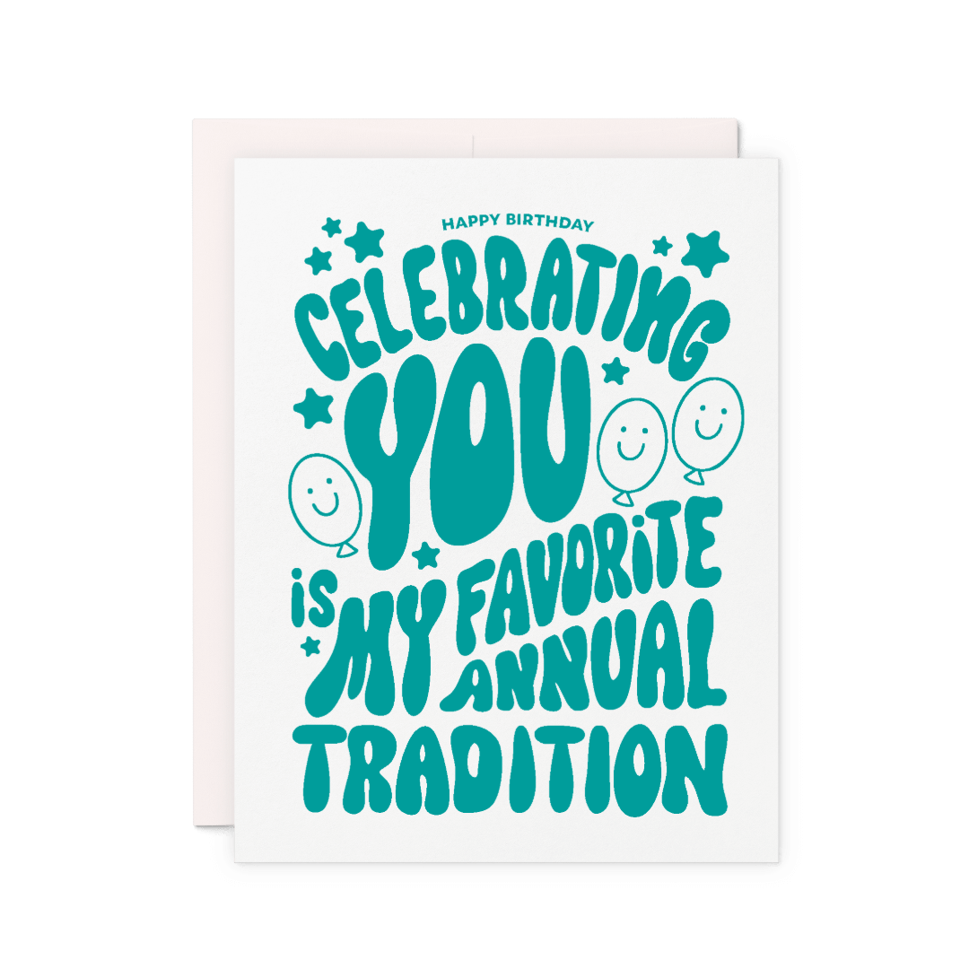 Birthday card that reads 'Celebrating you is my favorite annual tradition' in green hand lettering with balloons, stars, and smiley faces.
