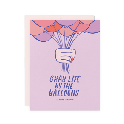 Funny birthday card with 'Grab Life by the Balloons' and an illustration of a hand gripping balloons, digitally printed on thick cotton paper.
