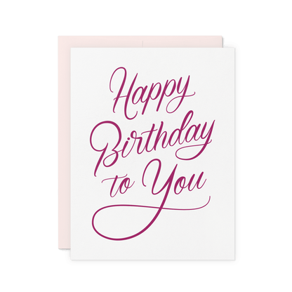 Elegant letterpress birthday card with 'Happy Birthday to You' in magenta script on thick cotton paper.