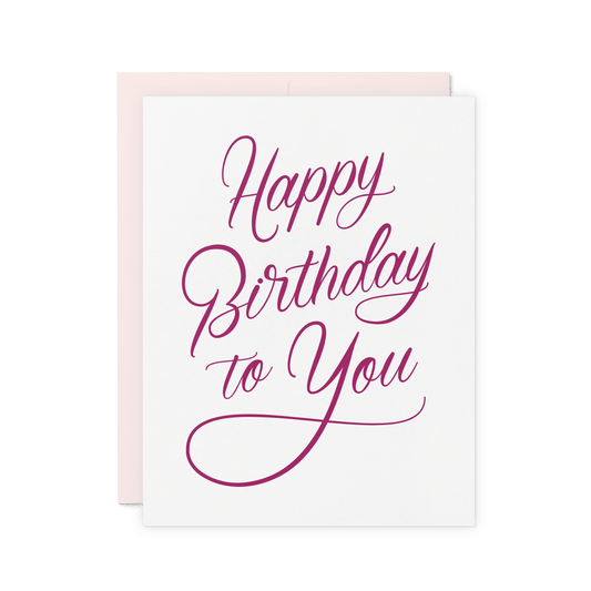 Elegant letterpress birthday card with 'Happy Birthday to You' in magenta script on thick cotton paper.
