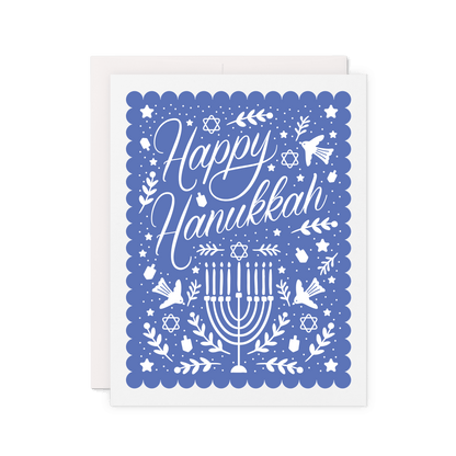 Greeting card with 'Happy Hanukkah' in white elegant script and menorah design surrounded by stars, dreidels, olive branches, and birds on a blue scallop border background.