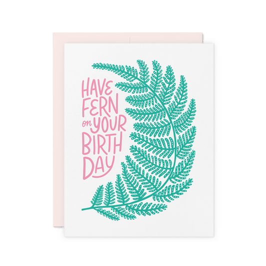 Botanical birthday card with a hand-drawn fern and pink hand-lettered text reading 'Have Fern on Your Birthday'.