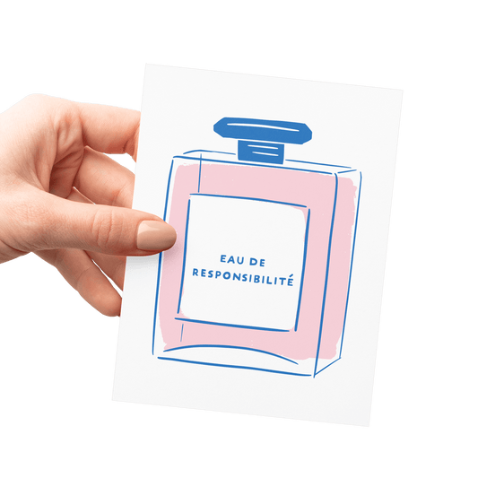 Hand holding funny congratulations card with perfume bottle illustration labeled 'Eau de Responsibilité,' letterpress printed.
