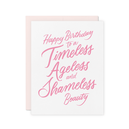 Funny birthday card with 'Happy Birthday to a Timeless, Ageless, and Shameless Beauty' in pink hand lettering, letterpress printed on thick cotton paper.
