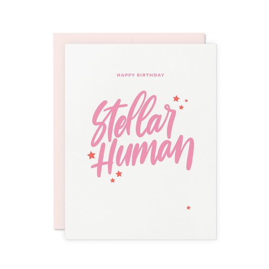 Celestial birthday card with 'Stellar Human' in pink hand lettering and star details, letterpress printed on thick cotton paper.