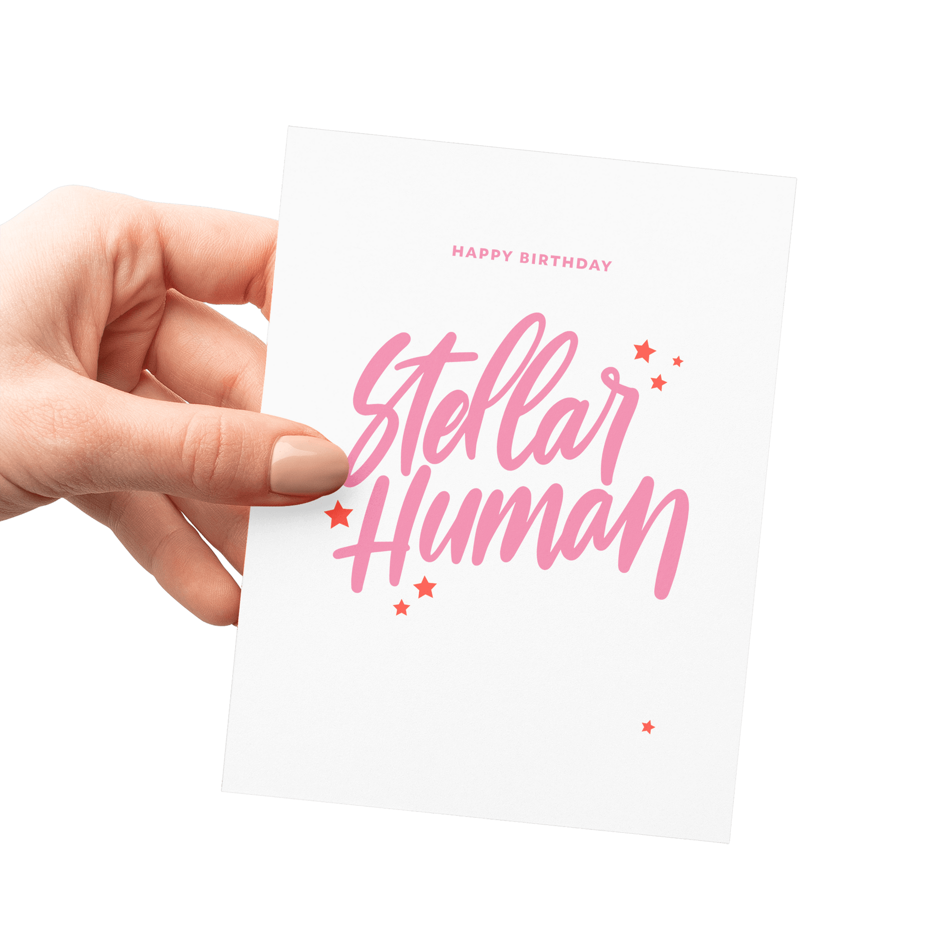 Hand holding a 'Stellar Human' celestial birthday card with pink hand lettering and star details.