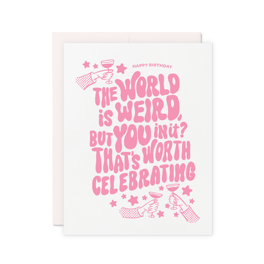Birthday card that reads 'The world is weird, but you in it? That’s worth celebrating' in pink hand lettering with stars and illustrated hands raising glasses.